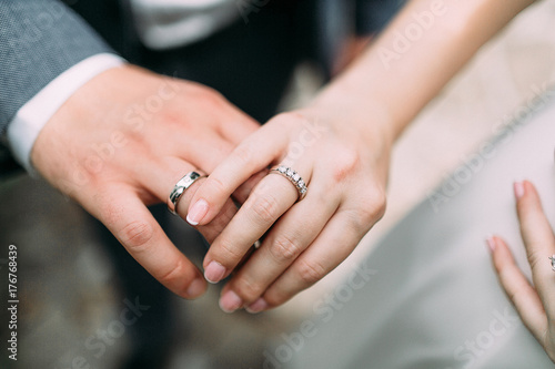 Just married young couple showing up their rings. Artwork. Soft focus photo