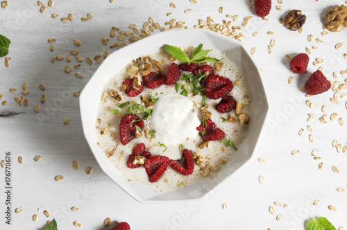 Overnight bircher muesli with walnuts, raspberry and mint photo