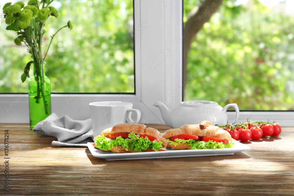 Tasty croissant sandwiches on windowsill Tasty croissant sandwiches on windowsill