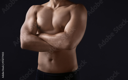 Sporty young man on dark background