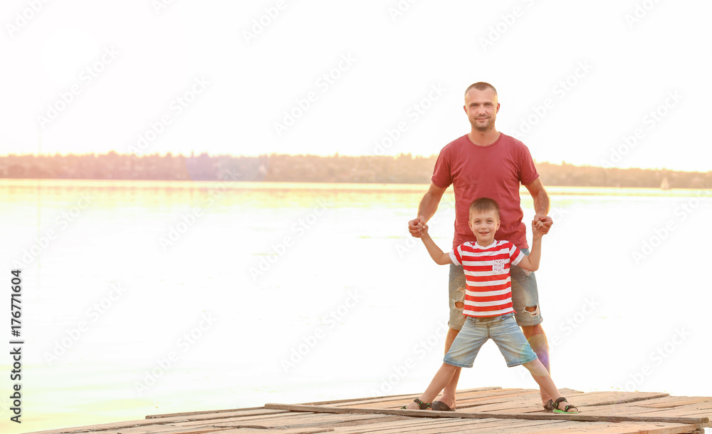 Cute boy with father on pier Cute boy with father on pier