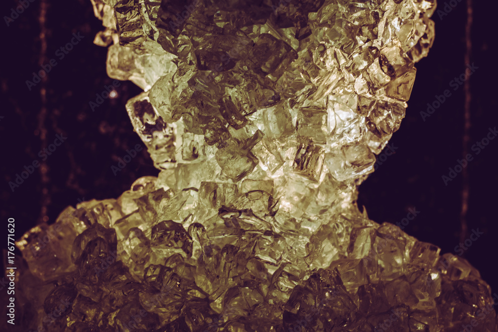 Obraz premium freezing macro close up melting ice golden shining glass