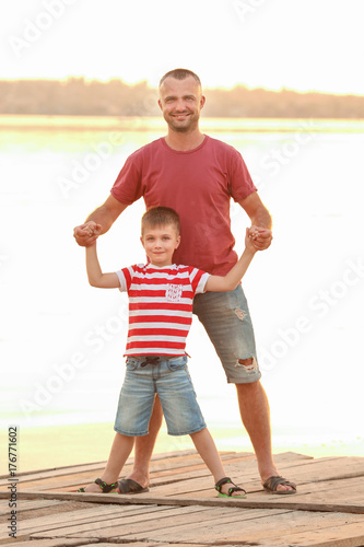 Cute boy with father on pier