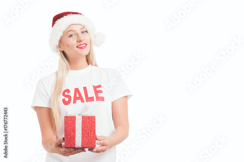 Beautiful cheerful fashion christmas girl in Santa's hat with gift box over white