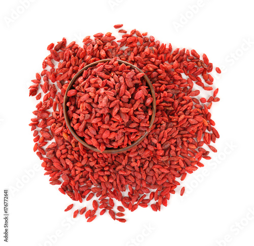Bowl with red dried goji berries on white background