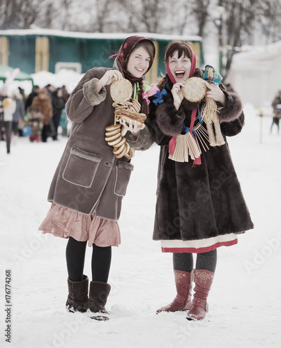 Women  tasting pancake  during  Shrovetide photo