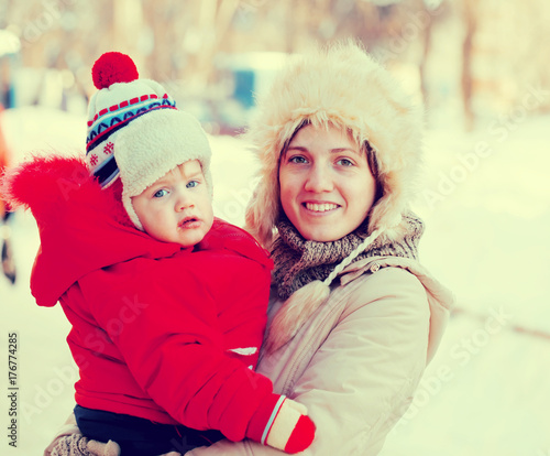  happy mother with toddler in winter
