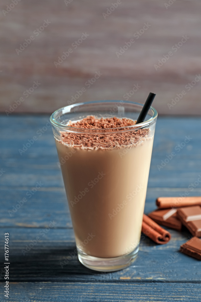 Glass with chocolate protein shake on wooden table Glass with chocolate protein shake on wooden table