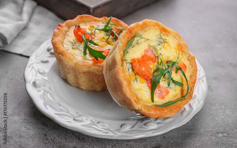 Plate with tasty salmon tartlets on table Plate with tasty salmon tartlets on table