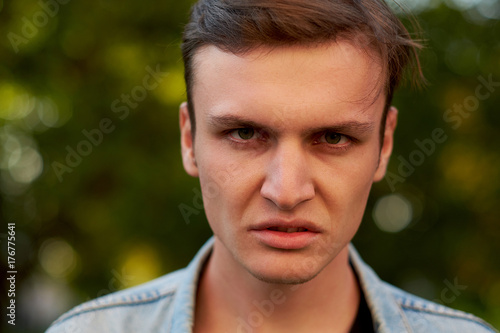 Angry aggressive man face. Problems in communication, quarrels and hatred, hard divorce concept