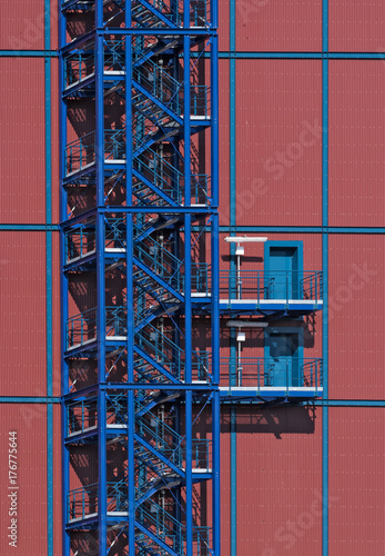 Blue metall staircase on red industrial building