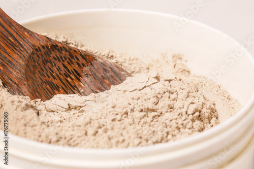 Cosmetic clay powder in the plastic container photo