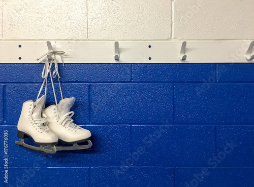 Figure skates hanging on locker room  photo