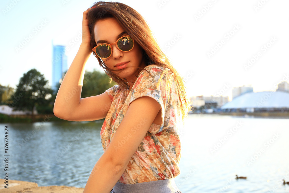 Woman with white teeth thinking and looking sideways in a park in summer Woman with white teeth thinking and looking sideways in a park in summer