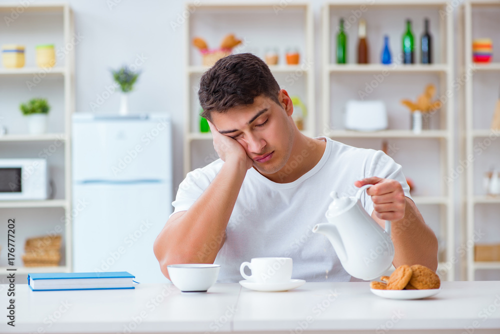 Man falling asleep during his breakfast after overtime work Man falling asleep during his breakfast after overtime work