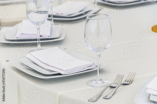 Beautifully decorated table for a celebration in a restaurant in white colors.