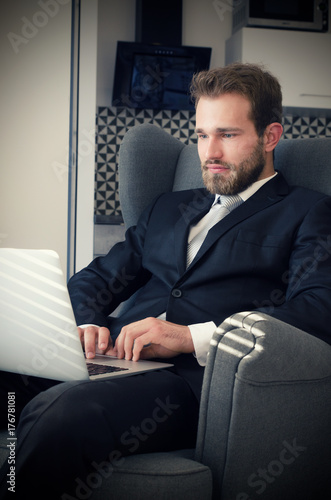 Young business man working from home with laptop