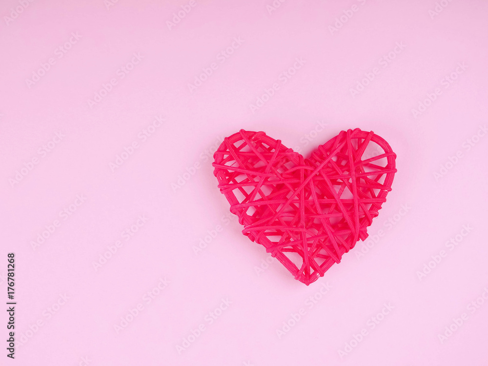 one red heart on a blue background and the background of pink feathers, lightness and romance for Valentine's day