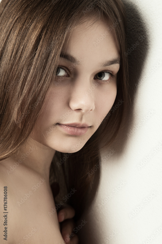 sensual girl near wall looking at camera, smiling sensual girl near wall looking at camera, smiling