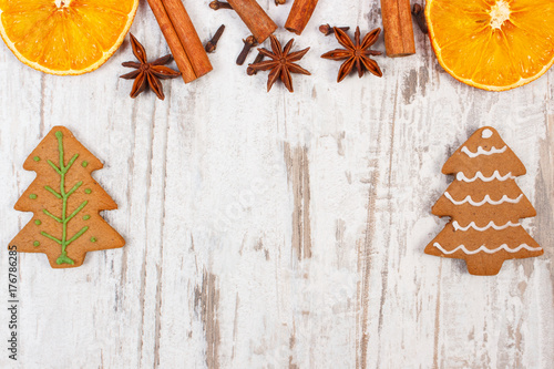 Fresh baked gingerbread with spices on old rustic board, Christmas time concept