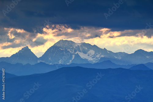 Snowy Hochgall   Collalto and Wildgall   Collaspro peaks and blue ridges of Rieserferner   Vedrette di Ries group High Tauern in the evening with sunlit clouds  Bolzano   South Tyrol province  Italy