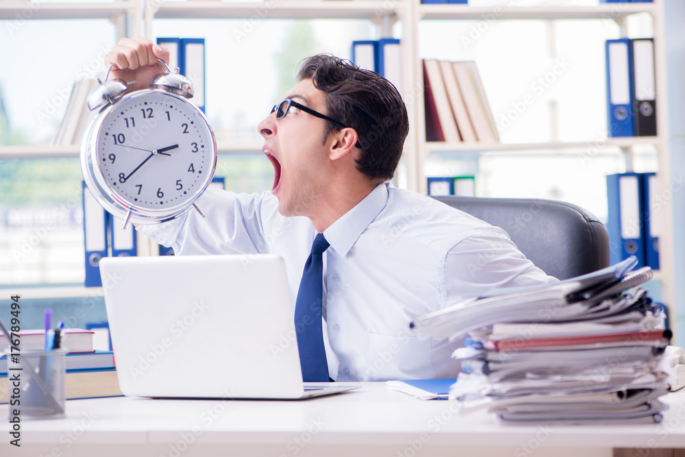 Businessman missing deadline for deliverables in office Businessman missing deadline for deliverables in office
