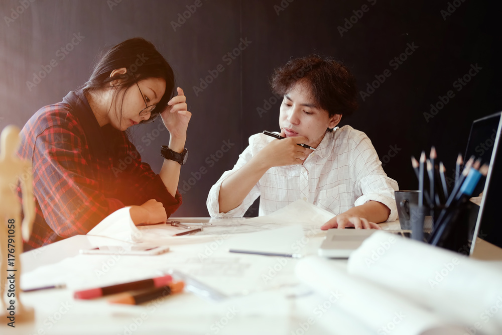 Architects working on plans at business boardroom table. Architect drawing on architectural project. Architectural plan Architects working on plans at business boardroom table. Architect drawing on architectural project. Architectural plan