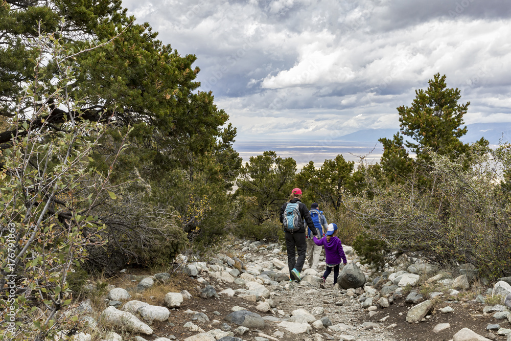A family hiking in the mountains above Great Sand Dunes National Park in Colorado.