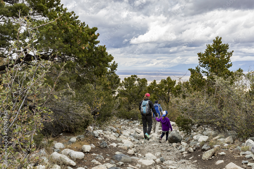 Fototapeta premium A family hiking in the mountains above Great Sand Dunes National Park in Colorado.