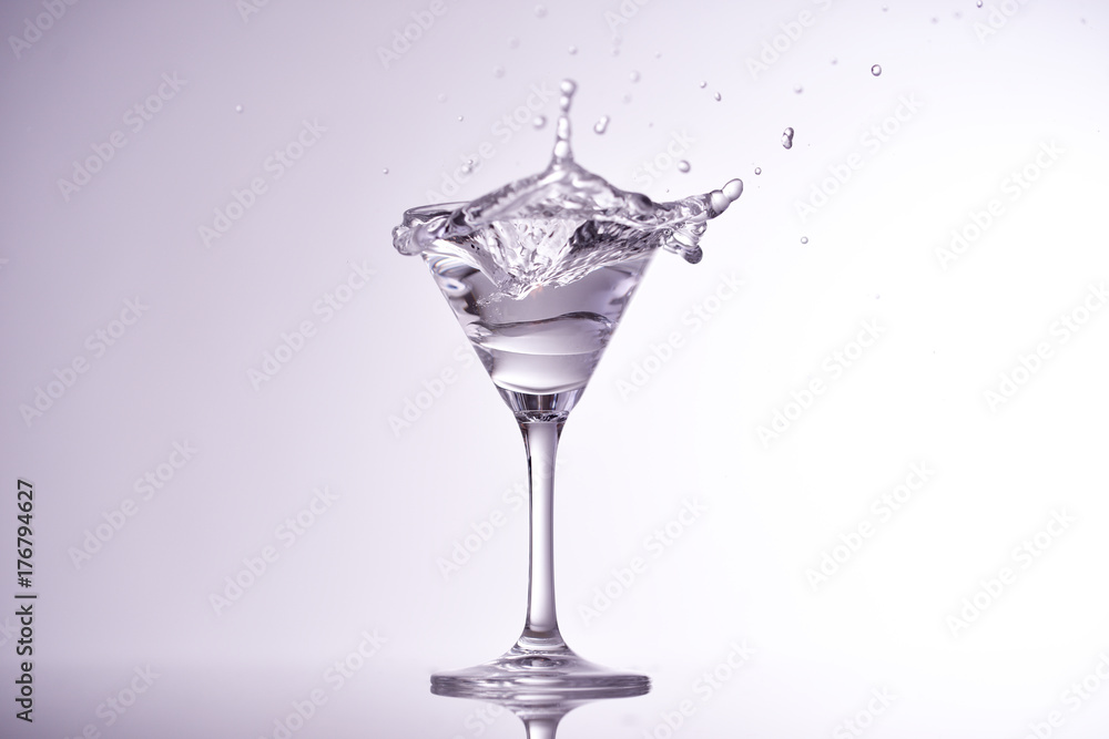 ice cube falling into glass of water ice cube falling into glass of water