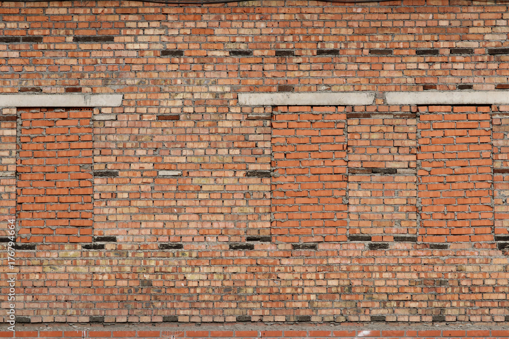 Obraz premium Old brick wall with walled windows
