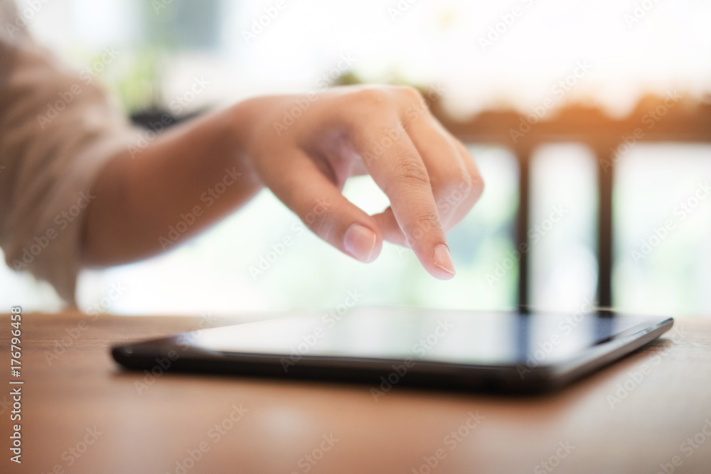 Close up of mans hands using tablet on counter. Close up of mans hands using tablet on counter.