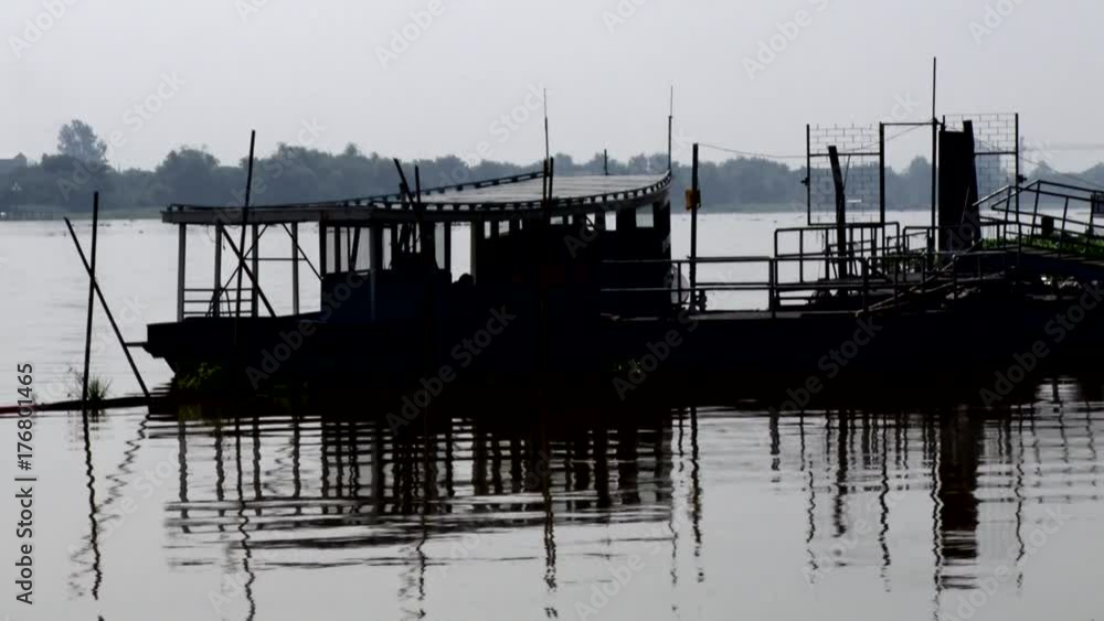 silhouette ferry boat docking in river waiting for passenger silhouette ferry boat docking in river waiting for passenger
