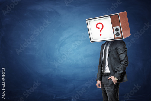 Картината върху платно A businessman has one hand in a pocket and a head replaced by an oil TV with a question mark on the screen