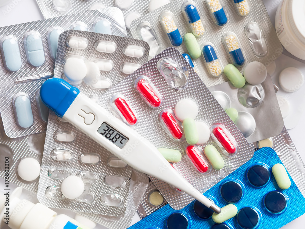 Many tablets and digital thermometer with a high temperature Many tablets and digital thermometer with a high temperature