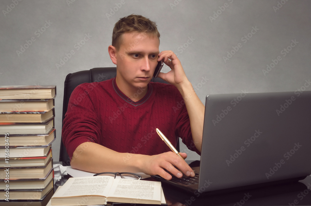 Hardworking businessman working with laptop computer on the office desk table. Student studying and looking for information in internet by using laptop computer. Hardworking businessman working with laptop computer on the office desk table. Student studying and looking for information in internet by using laptop computer.