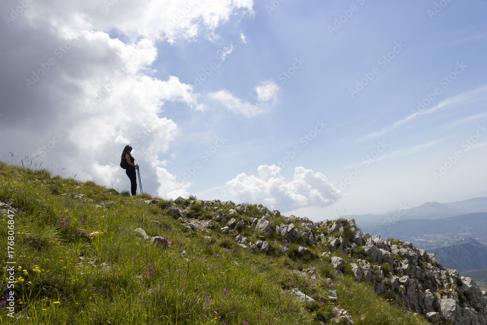 woman hiker on green mountain