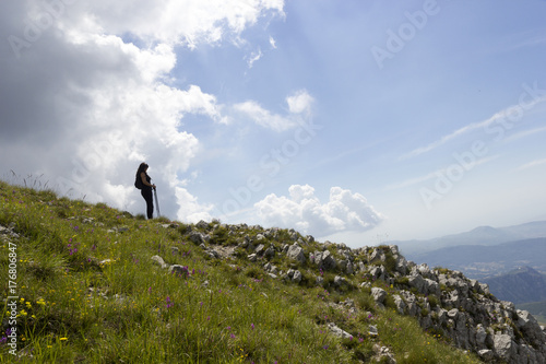 woman hiker on green mountain