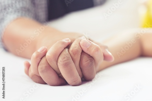 Billede på lærred Hands stranglehold of couple lovers on a bed at honeymoon with lust and love