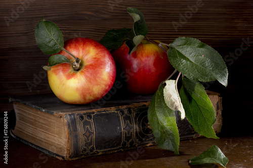 Apples fruit autumn green leaves vitamins book wooden table still life