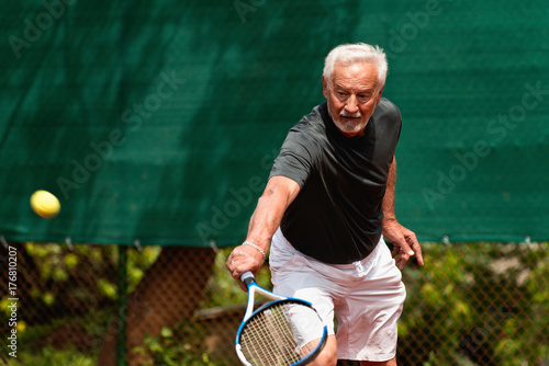 Senior Man Playing Tennis © Microgen