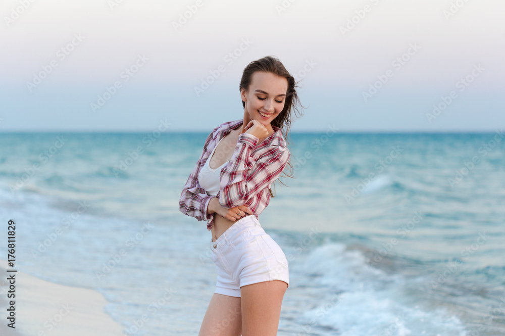 Happy carefree woman on the beach enjoying summer Happy carefree woman on the beach enjoying summer