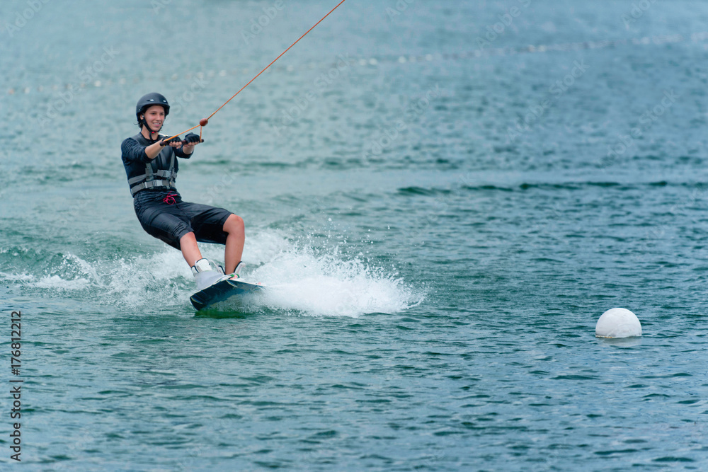 Young woman wakeboarding on lake Young woman wakeboarding on lake