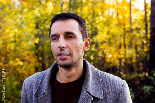 Autumn portrait of the thoughtful man which exhales smoke