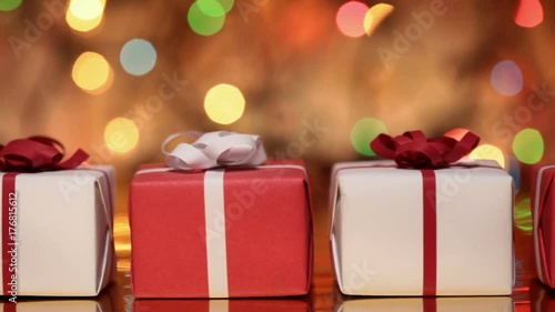 Slide in front of presents - gift boxes for christmas or other events against blurry slowly blinking lights