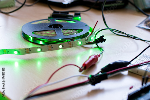 RGB led strip addressable controlled by a microcontroller open source to have green color flux. Maker project for DIY environment lighting. Lights for wearable photo