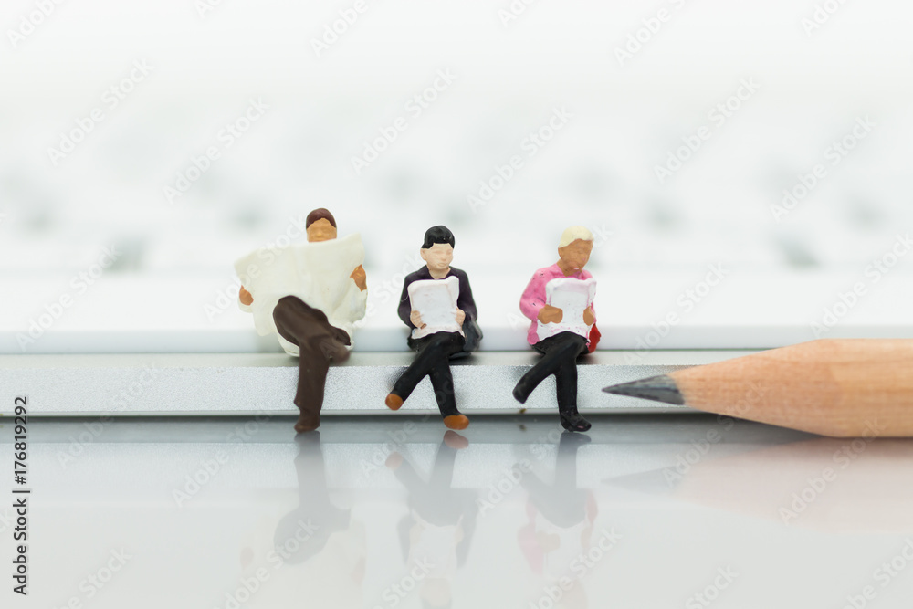Miniature people sitting on keyboard using as background education or business concept. Miniature people sitting on keyboard using as background education or business concept.