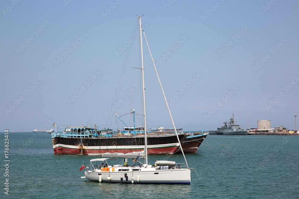 Luxury sailing boat, fishing and cargo ships at anchor in the port of Djibouti