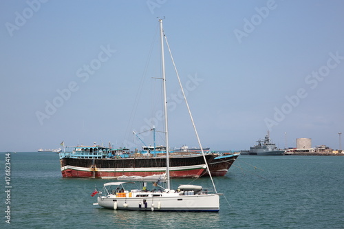 Luxury sailing boat, fishing and cargo ships at anchor in the port of Djibouti