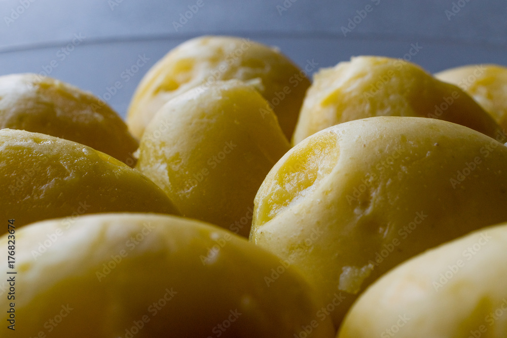 Boiled Potatoes in glass bowl on grey surface. Boiled Potatoes in glass bowl on grey surface.